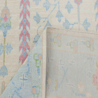 Persian-style tree-of-life hand-knotted rug with vertical garden motifs in ivory and blue pastels, 8x10