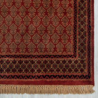 Persian/Afghan Gabbeh-style hand-knotted rug with Kashkuli leaf motifs in rust and brown on terracotta ground