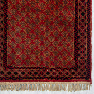 Persian Gabbeh-inspired hand-knotted rug with small leaf motifs and geometric border in cherry red, rust, brown
