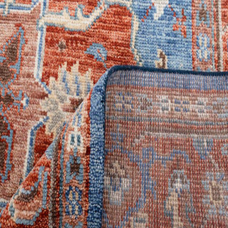 Persian Heriz-style hand-knotted rug with tribal geometric and floral motifs in blue, rust, beige tones.