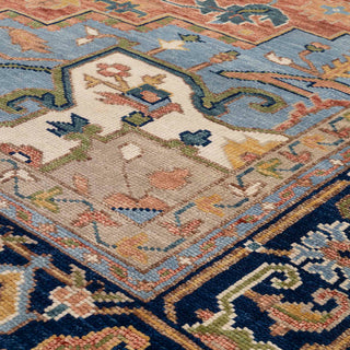 Persian Heriz hand-knotted rug with tribal medallion motif in rust, navy, blue, and cream tones.