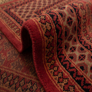 Persian/Indian Gabbeh hand-knotted rug with tribal floral motifs and geometric borders in brick red and camel