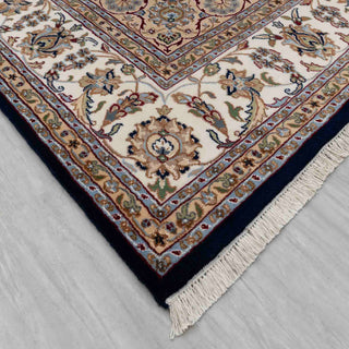 Persian Isfahan-style hand-knotted rug with intricate medallion and floral motifs in navy, ivory, 8x10.
