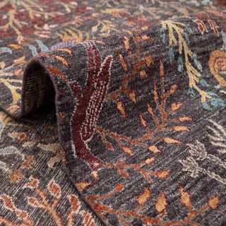 Persian style hand-knotted rug with animal garden and tree-of-life motifs in charcoal, rust, teal and ivory.