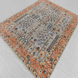 Persian style hand-knotted rug with garden and vine motifs in blue, terracotta, ivory and sage