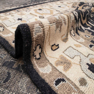 Persian village style hand-knotted rug with bold central lattice and stylized flowers in charcoal and sand tones.