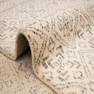 Scandinavian-style hand-knotted rug with subtle tribal diamond motifs in ivory, taupe tones