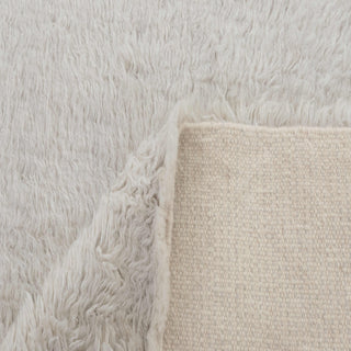 Scandinavian style hand-knotted rug with minimalist shag motif in warm ivory tones