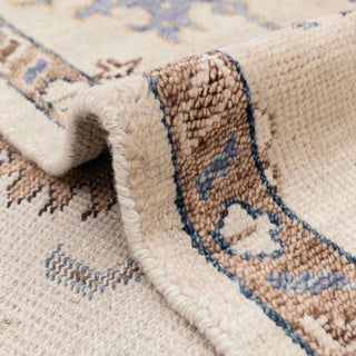 Soft wool 8x10 living room rug, ivory field, subtle blue and gold accents, low pile, durable.