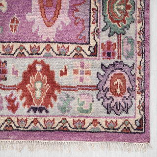 Soft wool 8x10 living room rug, purple field, colorful motifs, low pile, bold boho statement carpet.