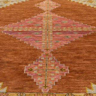 Southwestern-style hand-knotted rug with bold diamond medallion motif in rust, peach, and beige.