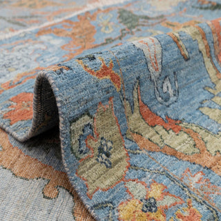 Tabriz-style hand-knotted rug with symmetrical palmette motif in turquoise rust terracotta.