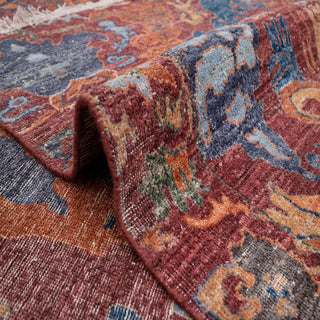 Tabriz-style hand-knotted rug with symmetrical vine motif in aubergine rust teal.