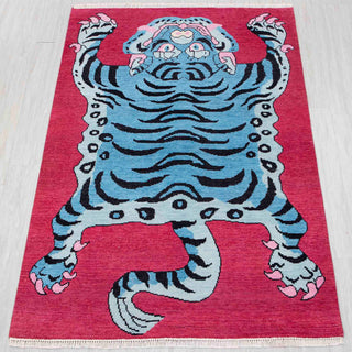 Tibetan-style hand-knotted rug in pink and blue with tiger design, 5x7 ft statement piece