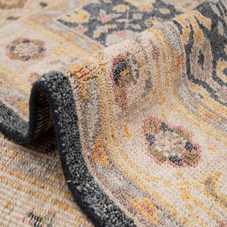 Traditional Oushak-style hand-knotted rug with soft floral motif in charcoal, cream, and honey tones.