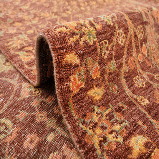 Traditional Persian style hand-knotted rug with allover garden and cypress motifs in warm rust and gold tones.