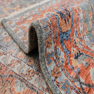 Traditional Persian style hand-knotted rug with chahar bagh garden motifs in slate blue and warm terracotta.