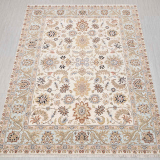 Traditional hand-knotted rug in ivory, blue, beige with floral design, 9x12 ft area.