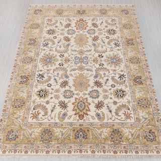 Traditional hand-knotted rug in ivory, gold, blue with floral medallion design, 9x12 size.