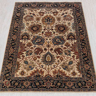 Traditional hand-knotted rug in ivory, navy, and teal with ornate Persian floral design, 5x7 size.
