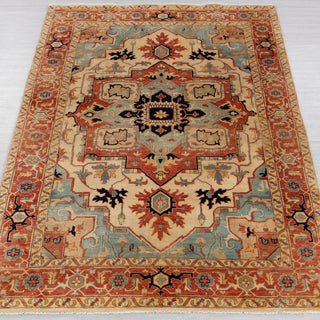 Traditional hand-knotted rug in ivory, rust, and teal with bold Heriz Serapi medallion design, 5x8 size.