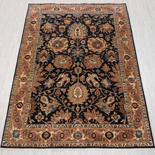 Traditional hand-knotted rug in navy, camel, and ivory with dense Persian floral design, 5x7 size