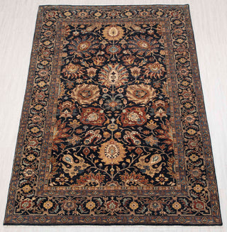 Traditional hand-knotted rug in navy, gold, and rust with dense Persian floral design, 6x9 size.