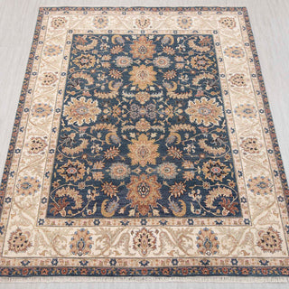 Traditional hand-knotted rug in navy, ivory, gold with floral design, 8x10 size.