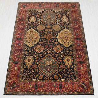 Traditional hand-knotted rug in navy, red, and gold with bold Persian floral design, 6x9 size.