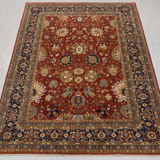 Traditional hand-knotted rug in rust, navy, and beige with detailed Persian floral design, oversized 10x14 size.