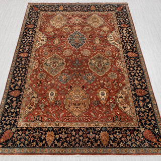 Traditional hand-knotted rug in rust, navy, and beige with floral medallion design, 9x12 room size