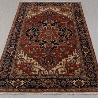 Traditional hand-knotted rug in rust, navy, and ivory with bold Heriz medallion design, 6x9 size
