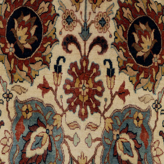 Traditional hand-knotted rug in ivory, rust, and blue with classic Persian floral design, 6x9 size