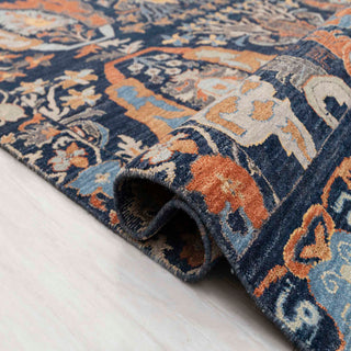 Transitional Oushak style hand-knotted rug with artistic botanical motif in navy, copper, sky blue.
