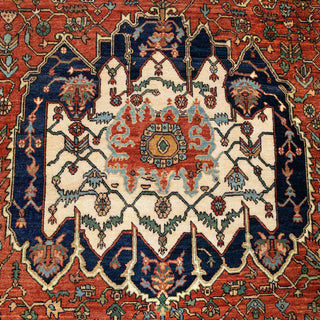 Tribal Caucasian-style hand-knotted rug with medallion and border motifs in rust, teal, ivory.