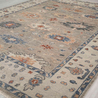 Turkish-style Oushak hand-knotted rug with allover floral motifs in soft grey, cream, and blue accents