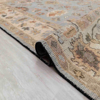 Turkish-style Oushak hand-knotted rug with soft blue field and cream floral border, multicolor accents, large 9x12.