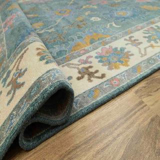 Turkish-style teal Oushak hand-knotted rug with colorful floral motifs and cream border, large 9x12.