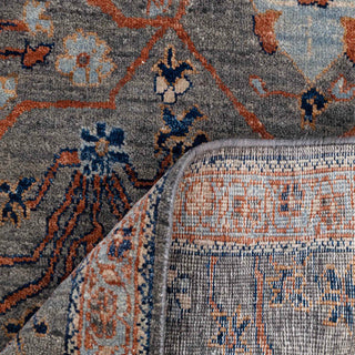 Turkish Oushak-style hand-knotted rug with distressed floral motif in charcoal, terracotta, and blue.