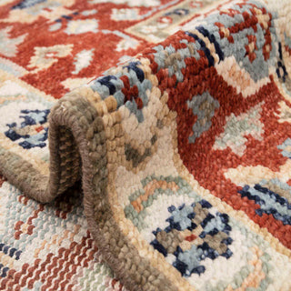 Turkish Oushak-style hand-knotted rug with geometric floral motif in ivory, rust, and blue