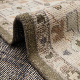 Turkish Oushak-style hand-knotted rug with geometric floral motif in olive green, ivory border.