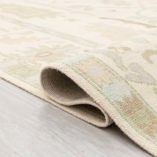 Turkish Oushak-style hand-knotted rug with muted tribal floral motifs in ivory and pastels, 9x12 size