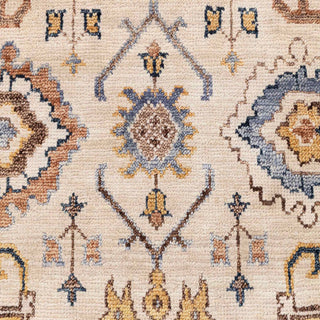 Turkish Oushak-style hand-knotted rug with scattered floral motif in ivory, blue, and tan tones.