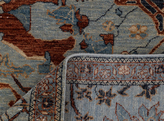 Turkish Oushak-style hand-knotted rug with tree-of-life floral motif in dusty blue and rust tones.