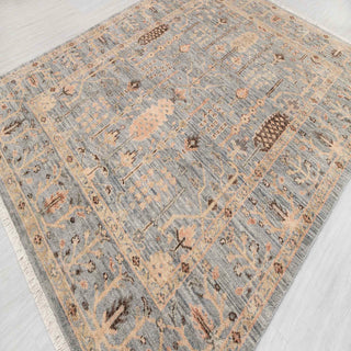Turkish Oushak-style hand-knotted rug with vertical botanical motif in blue-grey, sand, and brown.