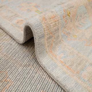 Turkish Oushak hand-knotted rug with faded floral medallion motifs on pale grey field, large 10x14 size.