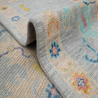 Turkish Oushak hand-knotted rug with large-scale pastel floral motifs on a light grey field