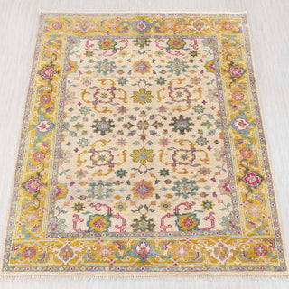 Wool hand-knotted rug in ivory, gold, teal, and pink with Persian floral design, 8x10.
