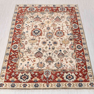 Wool hand-knotted rug in ivory, rust, and blue with Oushak floral design, 9x12 size.