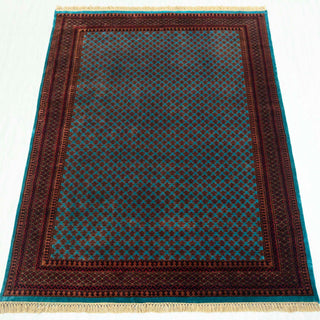 Wool hand-knotted rug in teal and rust with dense small floral pattern, 6x9 area rug